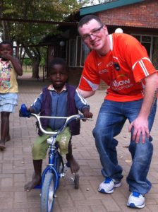 Kevin, our volunteer electrician, giving cycling lessons