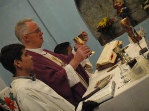 Celebrating Mass with his community in Parroquia La Santa Cruz