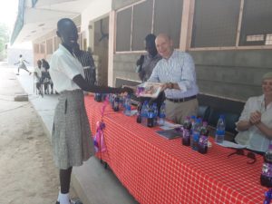 US ambassador presenting gifts to Loreto Rumbeck pupil