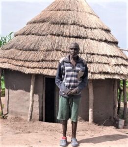 Marial outside his house in South Sudan