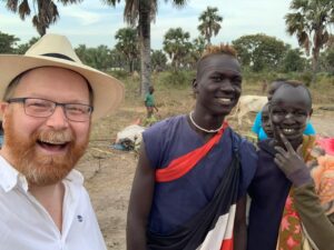 Fr. Alan meeting a few of the boys responsible for looking after the herd of cows in the cattle camp.