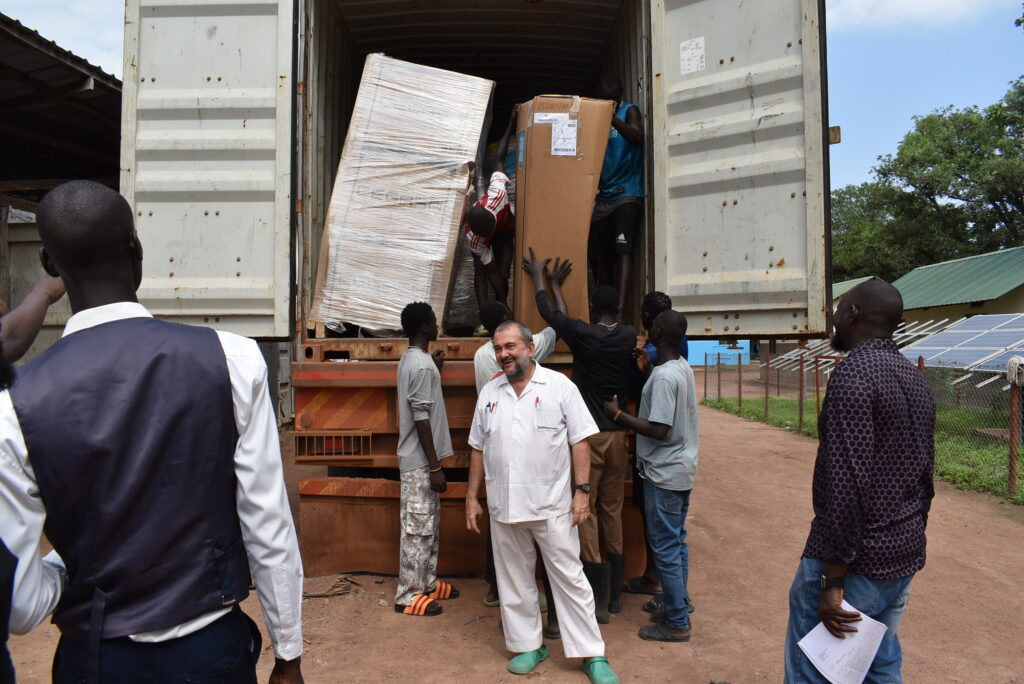Bro. Rosario, founder of Mary Immaculate Hospital, in Mapourdit, South Sudan, receiving supplies.