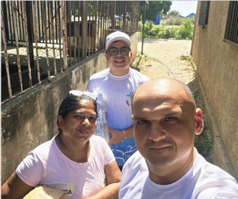 Missionary team with affected residents: Direct delivery session of drinking water and medical supplies to women in the community.