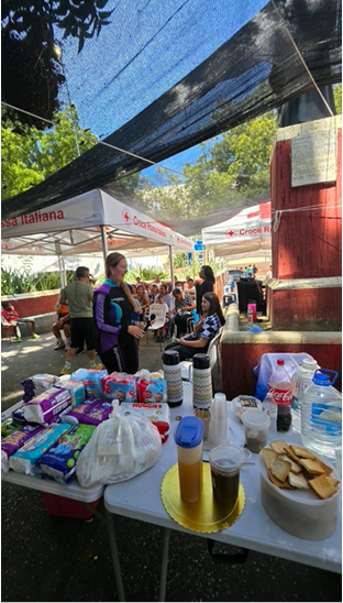 Operational and logistical setup in the square, featuring hygiene kits, diapers, supplies for elderly care, and hydration stations.