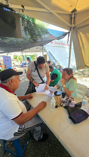 Individualized medical consultations and clinical record registration under shade tents set up in the square.